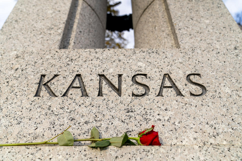 A single rose is left at the Kansas state pillar, the state which Bob Dole long represented in the Senate, at the World War II Memorial on the National Mall in Washington, Sunday, Dec. 5, 2021. Dole, who overcame disabling war wounds to become a sharp-tongued Senate leader from Kansas, a Republican presidential candidate and then a symbol and celebrant of his dwindling generation of World War II veterans, has died. He was 98. His wife, Elizabeth Dole, posted the announcement Sunday, on Twitter. (AP Photo/Andrew Harnik)