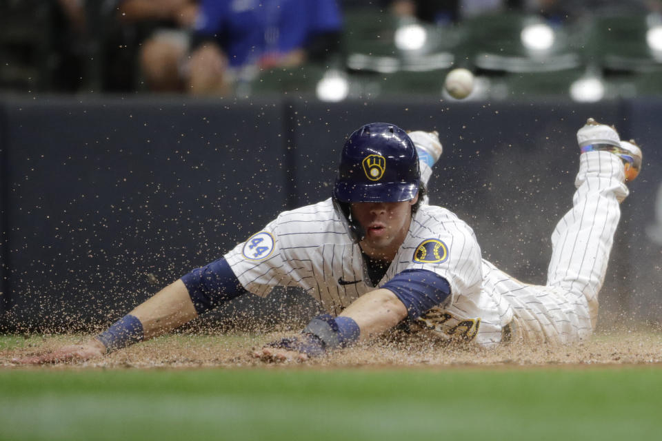 Milwaukee Brewers' Christian Yelich slides in safely at home after tagging up on a sacrifice fly hit by Avisail Garcia during the fifth inning of a baseball game against the New York Mets Friday, Sept. 24, 2021, in Milwaukee. (AP Photo/Aaron Gash)