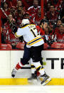 WASHINGTON, DC - APRIL 19: John Carlson #74 of the Washington Capitals and Milan Lucic #17 of the Boston Bruins battle against the glass in Game Four of the Eastern Conference Quarterfinals during the 2012 NHL Stanley Cup Playoffs at Verizon Center on April 19, 2012 in Washington, DC. (Photo by Patrick McDermott/Getty Images)