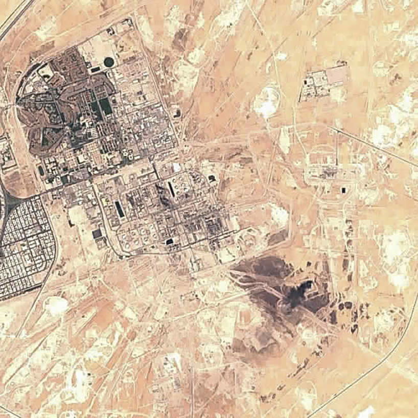 This Sunday, Sept. 15, 2019 false-color image from the European Commission's Sentinel-2 satellite shows Saudi Aramco's Abqaiq oil processing facility in Buqyaq, Saudi Arabia. Yemen's Houthi rebels claimed to have launched drone attacks on the world's largest oil processing facility in Saudi Arabia and a major oil field Saturday, sparking huge fires and halting about half of the supplies from the world's largest exporter of oil. Black char marks at the center of the facility suggest the attack struck at the heart of the processing facility (European Commission via AP)