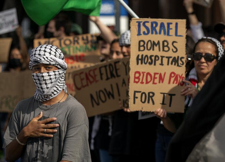 LOS ANGELES, CA-NOVEMBER 4, 2023, 2023:Musa Abdul Rahman, 21, left, joins other protesters, demanding an end to the Israeli invasion of Gaza during a pro-Palestinian rally outside the Israeli Consulate on Wilshire Blvd. in Los Angeles. (Mel Melcon / Los Angeles Times)