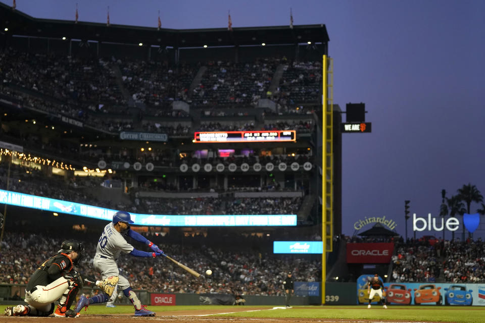 Los Angeles Dodgers' Mookie Betts, second from left, hits an RBI single in front of San Francisco Giants catcher Patrick Bailey during the fifth inning of a baseball game in San Francisco, Saturday, Sept. 30, 2023. (AP Photo/Jeff Chiu)