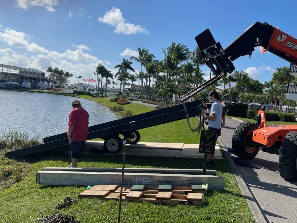 Workers position platform that will be used to float a car ahead of the 2023 Honda Classic at PGA National in Palm Beach Gardens on Feb. 10, 2023.
