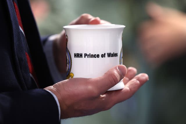 <p>Chris Jackson/Getty</p> Prince William holds a mug at RAF Valley on July 9, 2024.