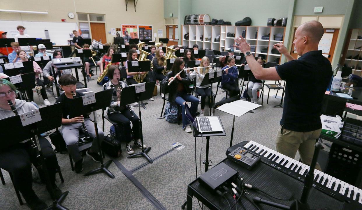Ames Middle school 8th grade band teacher couducts during practice for upcoming concert at the school on Wednesday, April 24, 2024, in Ames, Iowa.