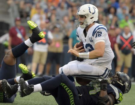 Aug 9, 2018; Seattle, WA, USA; Indianapolis Colts quarterback Andrew Luck (12) is sacked by Seattle Seahawks defensive end Rasheem Green (94) in the first quarter during a preseason game against the Indianapolis Coltsat CenturyLink Field. Kirby Lee-USA TODAY Sports