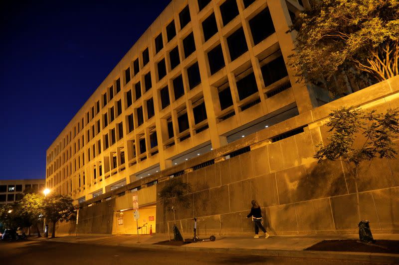 FILE PHOTO: A person walks by the Department of Labor headquarters in Washington, D.C.