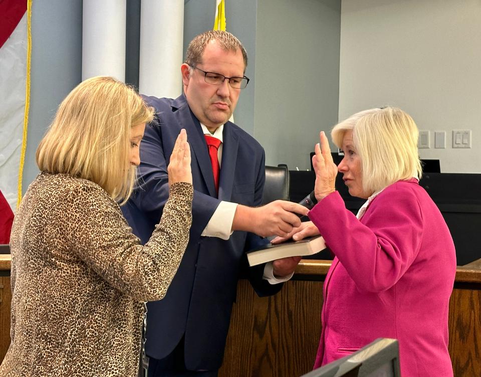 New Venice City Council Member Joan Farrell, right, recites the oath of office Tuesday morning. The oath was administered by City Clerk Kelly Michaels while Venice Mayor Nick Pachota held the Bible and a microphone.