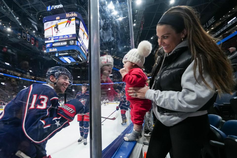 December 5, 2023; Columbus, Ohio, USA; Johnny Gaudreau (13), left winger for the Columbus Blue Jackets, waves to his wife Meredith and daughter Noa during warm-ups before the NHL game against the Los Angeles Kings at Nationwide Arena.