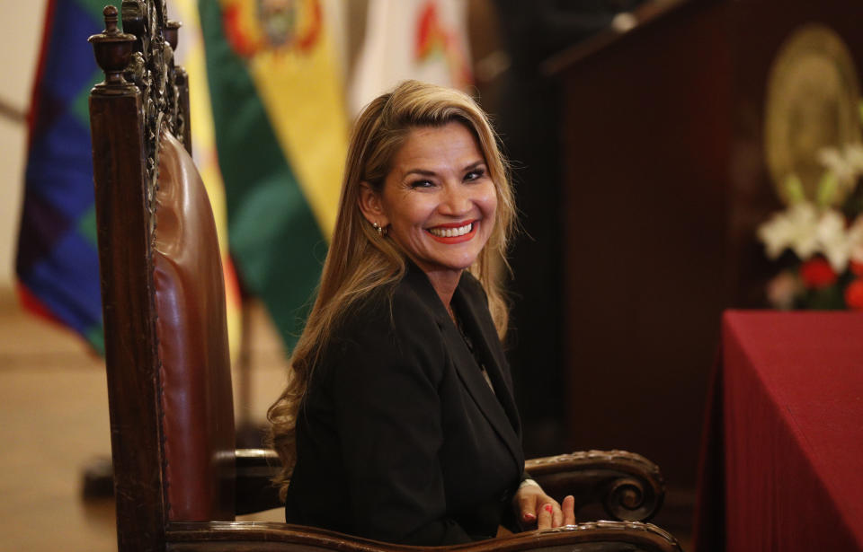 The opposition senator who has claimed Bolivia's presidency Jeanine Anez smiles during the swearing-in ceremony of her new cabinet at the presidential palace in La Paz, Bolivia, Wednesday, Nov. 13, 2019. Anez faces the challenge of stabilizing the nation and organizing national elections within three months at a time of political disputes that pushed former President Evo Morales to fly off to self-exile in Mexico after 14 years in power. (AP Photo/Juan Karita)