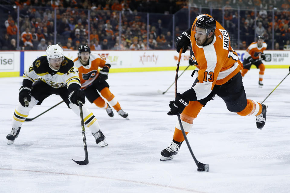 Philadelphia Flyers' Kevin Hayes, right, takes a shot past Boston Bruins' Chris Wagner during the second period of an NHL hockey game, Tuesday, March 10, 2020, in Philadelphia. (AP Photo/Matt Slocum)