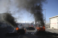 Smokes billows after protesters set vehicles on fire in the Mediterranean port city in Marseille, southern France, Thursday, Dec.12, 2019. Unions have flatly rejected fresh proposals by the government of pro-business President Emmanuel Macron to stagger the roll-out of a plan that would require France's youngest workers - people born after 1974 - to stay on the job until the age of 64 to get full pensions instead of age 62. (AP Photo/Daniel Cole)