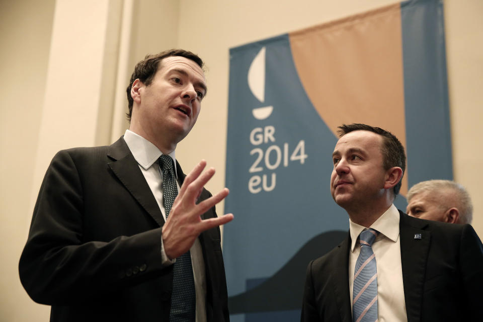 British Finance Minister George Osborne, left, chats with Irish Minister of State at the Department of Finance Brian Hayes during a European Finance ministers meeting at Zappeion Hall in Athens, on Wednesday, April 2, 2014.Greece will tap bond markets in the next three months for the first time since it needed international rescue loans in 2010, the country's finance minister said Tuesday, hours after fellow eurozone countries agreed to release more bailout funds. (AP Photo/Petros Giannakouris)