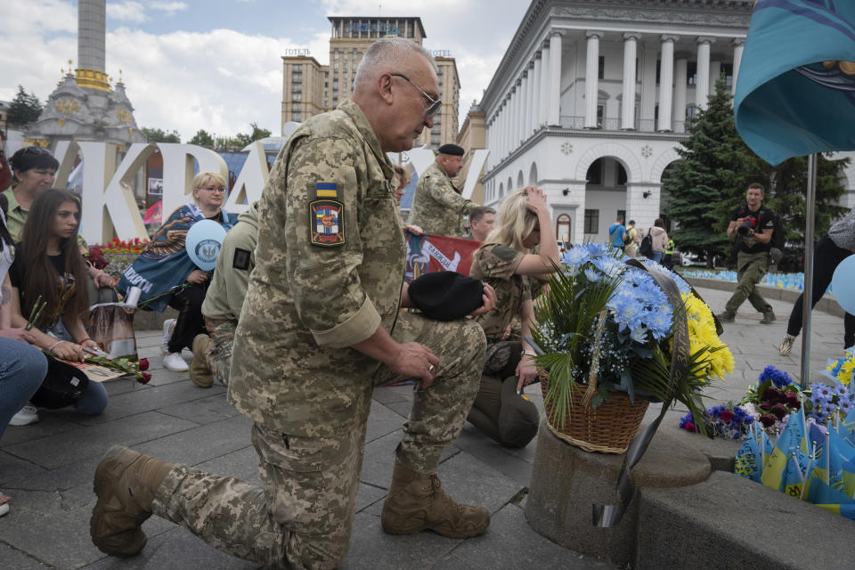 Veterans and people lay flowers at a spontaneous memorial to soldiers killed in war with Russia in the Independence square in Kyiv, Ukraine, Thursday, May 23, 2024. (AP Photo/Efrem Lukatsky)