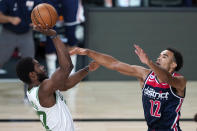 Boston Celtics' Semi Ojeleye, left, shoots as Washington Wizards' Jerome Robinson (12) defends during the second half of an NBA basketball game Thursday, Aug. 13, 2020 in Lake Buena Vista, Fla. (AP Photo/Ashley Landis, Pool)