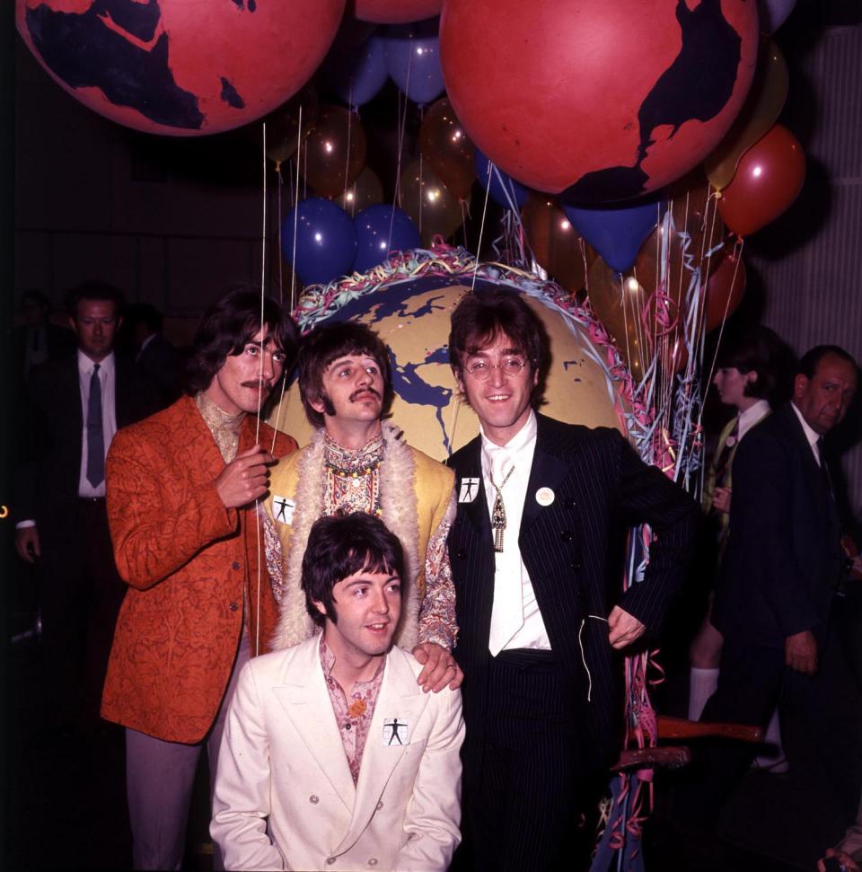 The Beatles at a recording session in London. Left to right- George Harrison, Ringo Starr, John Lennon and Kneeling Paul McCartney.   13/09/2003: The Beatles record label Apple is suing Apple Computers over its iTunes online music store, it emerged Friday September 12 2003. It has accused the US computer giant of breaching an agreement by using the apple logo and Apple name to promote music products. Apple Corps, the London-based company owned by Sir Paul McCartney, Ringo Starr, and the widows of John Lennon and George Harrison, has begun legal proceedings in the High Court. It is seeking damages and an injunction to enforce the terms of an agreement made in 1991.   (Photo by PA Images via Getty Images)