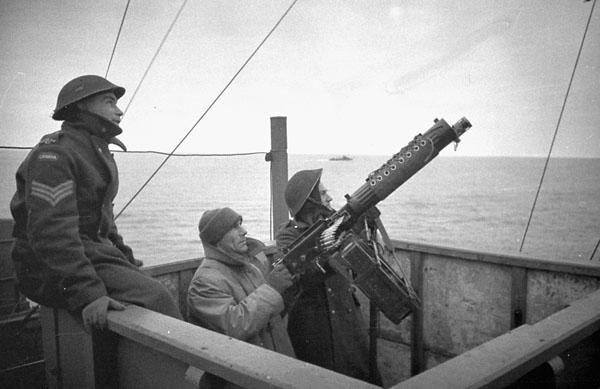 A Canadian machine gun crew aboard H.M. Transport EMPRESS OF CANADA, which is taking part in Operation GAUNTLET, the Spitsbergen raid, en route to Spitsbergen, ca. 19-24 August 1941.