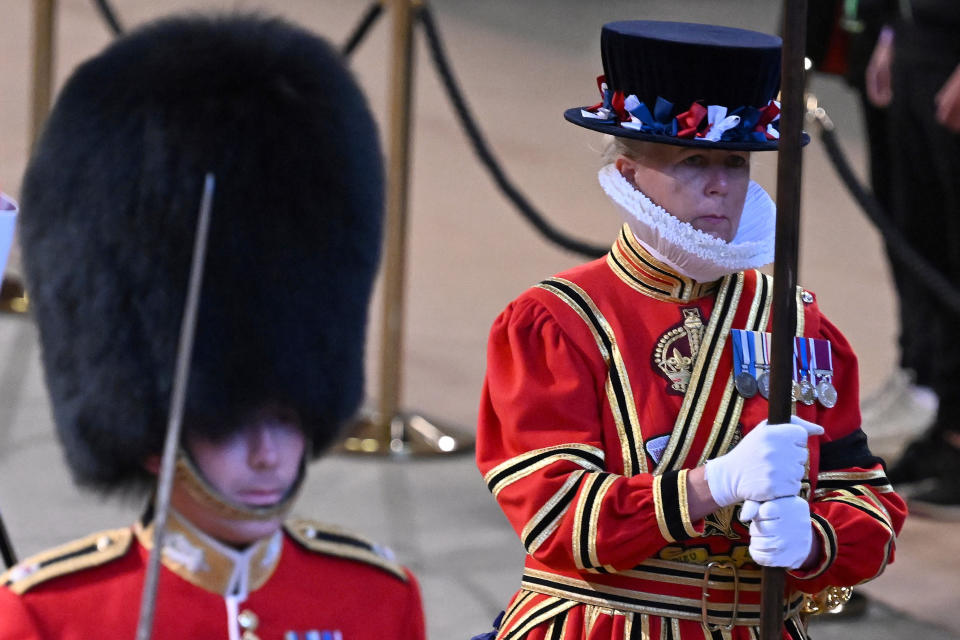 The King's Bodyguard the Yeomen of the Guard, right, and the Scots Guards change shifts after guarding the coffin past the coffin of Queen Elizabeth II during its lying in State inside Westminster Hall, at the Palace of Westminster in London, Sunday, Sept. 18, 2022. (Paul Ellis/Pool Photos via AP)