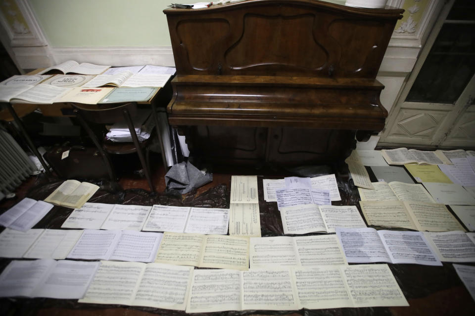 Ancient music sheets are placed to dry at the first floor of Venice Conservatory after being recovered from ground floor, Italy, Saturday, Nov. 16, 2019. High tidal waters returned to Venice on Saturday, four days after the city experienced its worst flooding in 50 years. Young Venetians are responding to the worst flood in their lifetimes by volunteering to help salvage manuscripts, clear out waterlogged books and lend a hand where needed throughout the stricken city.(AP Photo/Luca Bruno)