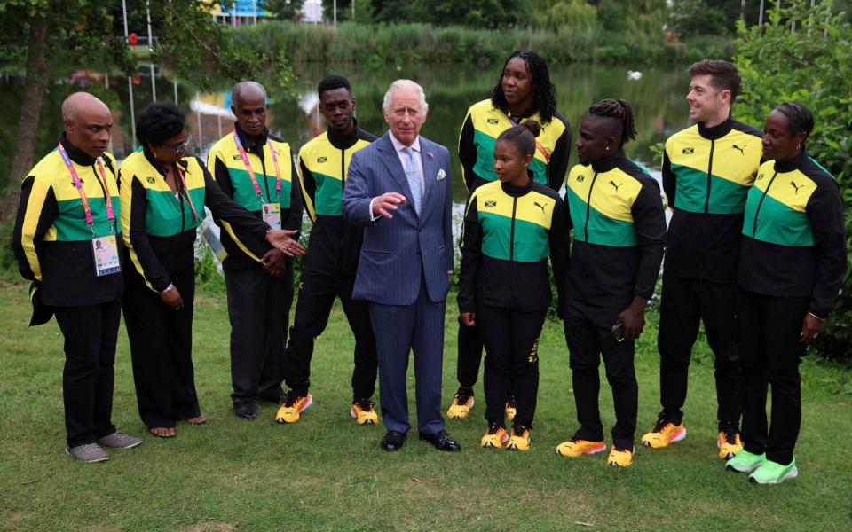 Britain's Prince Charles meets with athletes and members of the team Jamaica during a visit to the Athletes Village - Reuters