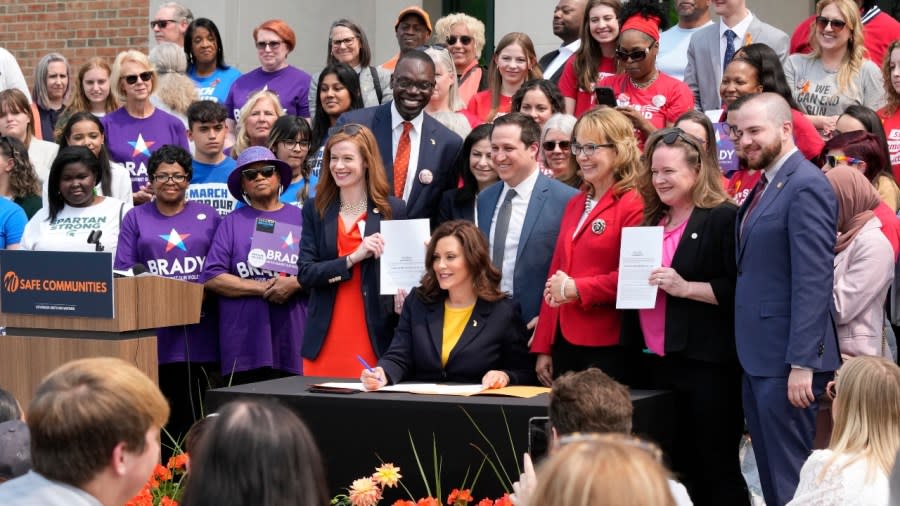 Michigan Gov. Gretchen Whitmer signs legislation in May in Royal Oak, Mich. Fueled by election gains, Democrats in Michigan and Minnesota this year enacted far-reaching policy changes that party leaders aspire to replicate on the national stage and in other states. (Photo: Carlos Osorio/AP, File)