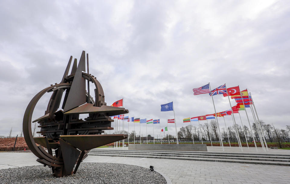 Flags of NATO member countries flap in the wind outside NATO headquarters in Brussels, Tuesday, Feb. 22, 2022. World leaders are getting over the shock of Russian President Vladimir Putin ordering his forces into separatist regions of Ukraine and they are focusing on producing as forceful a reaction as possible. Germany made the first big move Tuesday and took steps to halt the process of certifying the Nord Stream 2 gas pipeline from Russia. (AP Photo/Olivier Matthys)