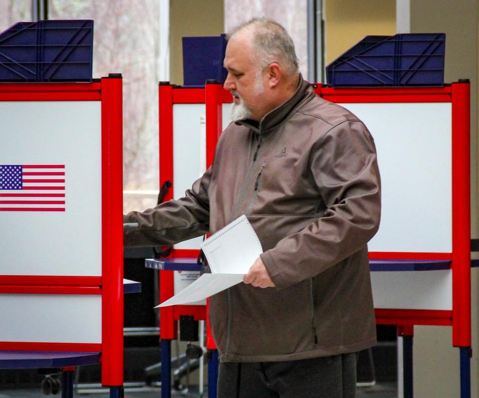 A voter finishes casting his presidential primary ballot at the Bristol Community College campus in Fall River on March 5, 2024.