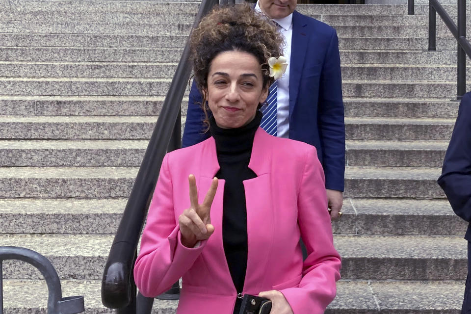 Masih Alinejad, an outspoken U.S.-based opponent of Iran's regime, flashes a v-sign as she leaves Manhattan federal court, Friday, April 7, 2023, in New York, after speaking at the sentencing of a California woman who pleaded guilty to a charge that she had an unwitting role in a foiled plot to kidnap Alinejad and take her back to Tehran. (AP Photo/Lawrence Neumeister)