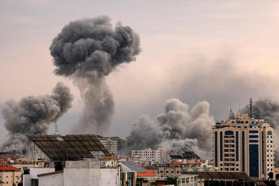A plume of smoke rises in the sky of Gaza City during an Israeli airstrike (AFP via Getty Images)