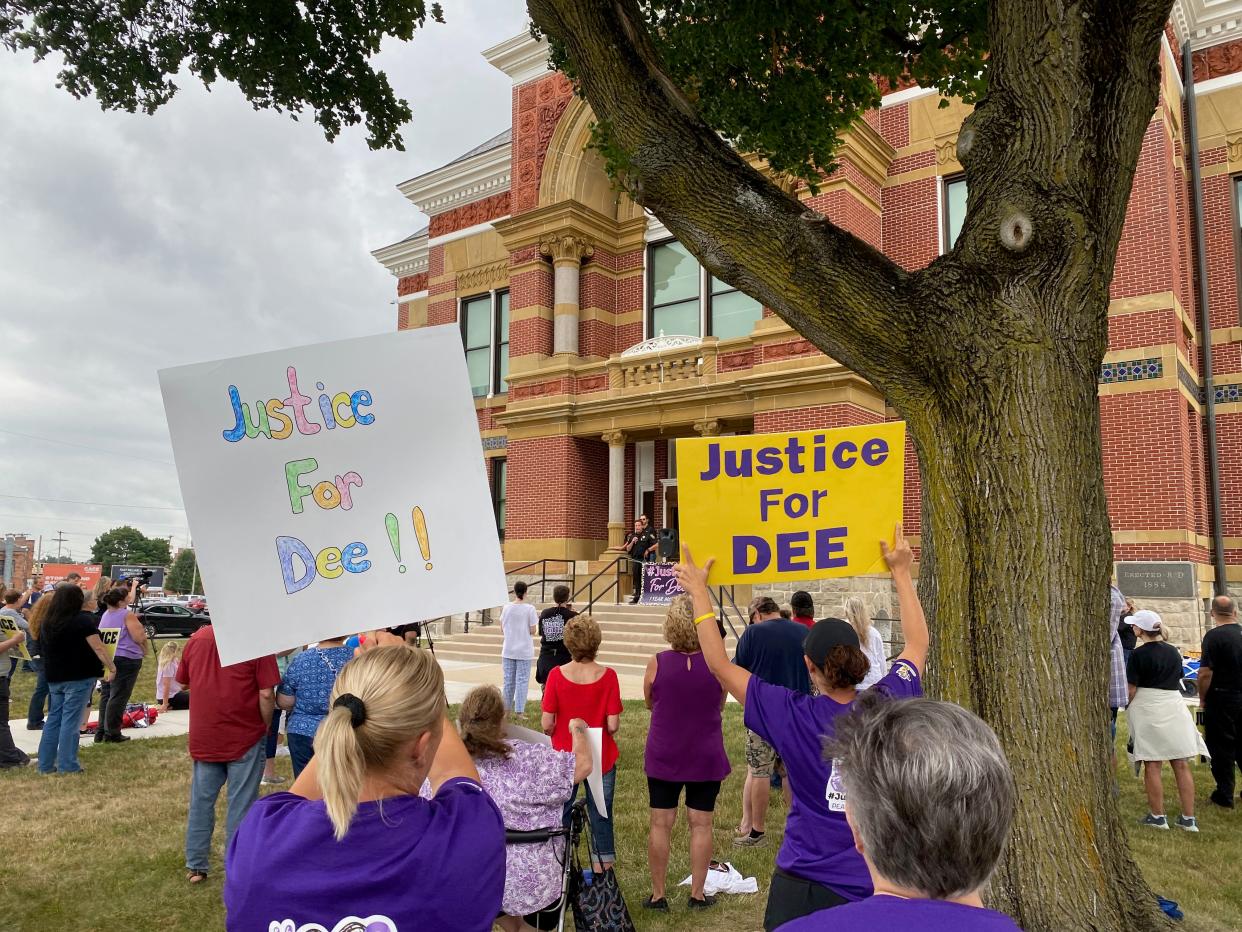 At a rally for missing Dee Warner on Monday at the old Lenawee County Courthouse in Adrian, people hold signs seeking justice for missing Dee Warner as Lenawee County Sheriff Troy Bevier announces he has asked the Michigan State Police to take over the investigation into what happened to Warner.