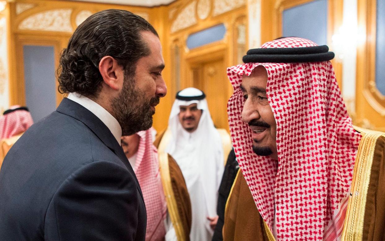 A handout picture provided by the Saudi Royal Palace on November 11, 2017, shows King Salman bin Abdulaziz al-Saud (R) shaking hands with former Lebanese prime minister Saad Hariri in the capital Riyadh - AFP