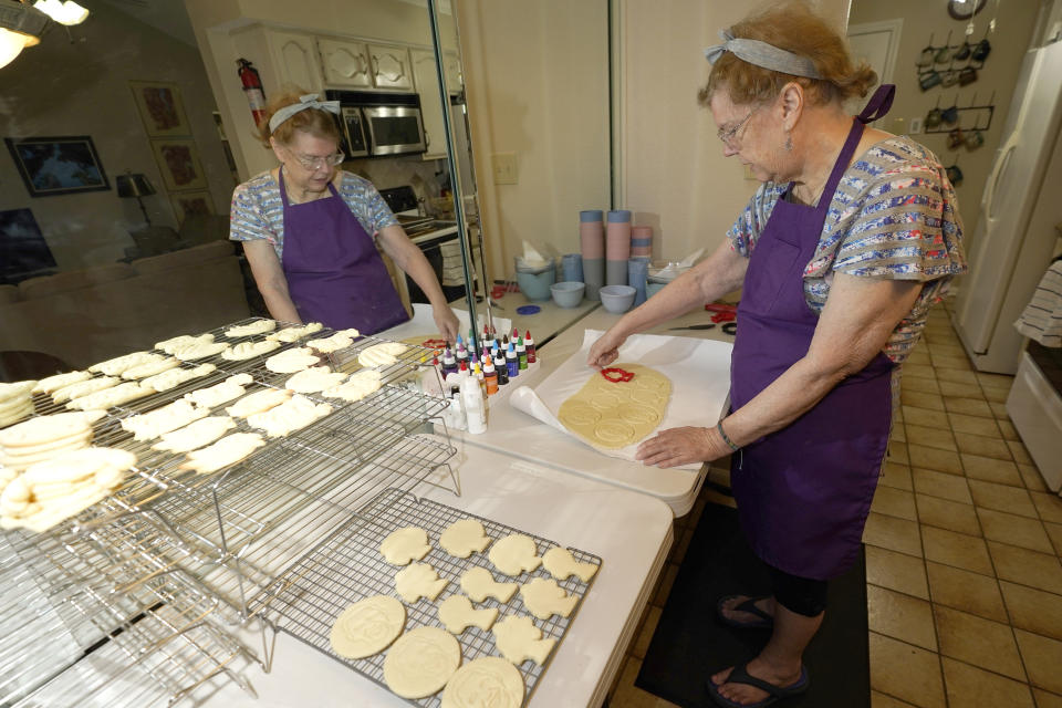 Julie Muller, who sells cookie decorating kits on Etsy, makes cutout cookies for her Black Lives Matter kits Tuesday, Sept. 22, 2020, in Houston. Amid all the Black Lives Matter themed T-shirts, face masks and signs appearing in recent months, some unconventional merchandise has been popping up on online crafts marketplace Etsy. (AP Photo/David J. Phillip)