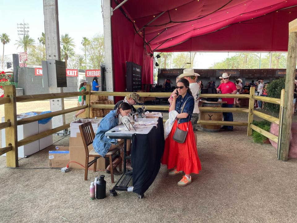 Stagecoach festivalgoers get a handkerchief embroidered at the "Yellowstone" tent.