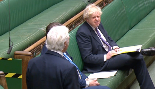 Boris Johnson grimaces at Sir Desmond Swayne during his attack on the government's lockdown. (Parliamentlive.tv)