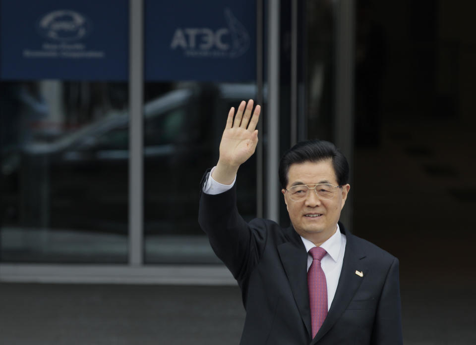 FILE - In this Sept. 8, 2012 file photo, Chinese President Hu Jintao waves as he arrives for the Leaders Meeting at the APEC summit in Vladivostok, Russia. As Hu steps down as head of China’s Communist Party after 10 years in power, he’s hearing something unusual for a Chinese leader: sharp criticism. (AP Photo/Ivan Sekretarev, File)