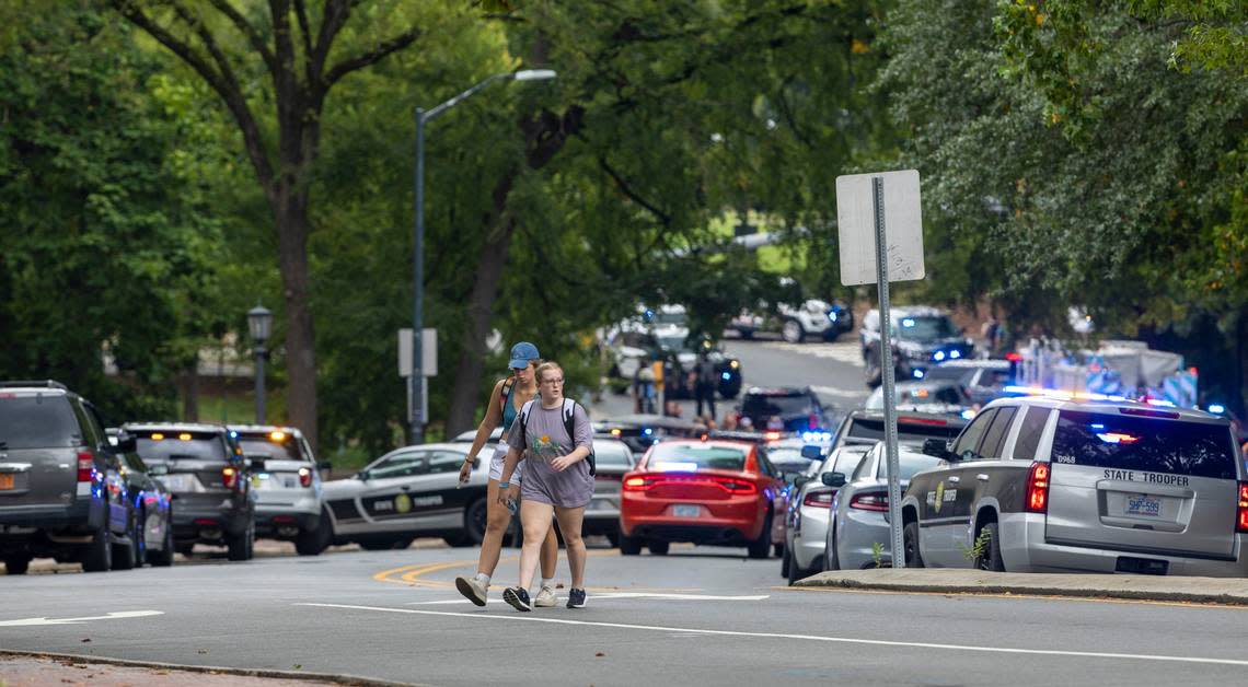 Students walk along South Road after a report of an armed and dangerous person on the University of North Carolina campus on Monday, August 28. 2023 in Chapel Hill, N.C.