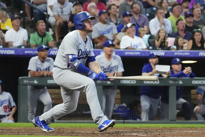 Dodgers' Max Muncy (13) watches the flight of a solo home run ball hit off Colorado pitcher Kyle Freehand on June 28.