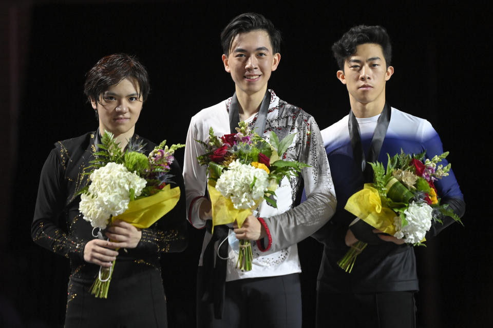 Second-place Shoma Uno, of Japan; first-place Vincent Zhou; and third-place Nathan Chen, from left, pose for a photo after the men's competition at the Skate America figure skating event Saturday, Oct. 23, 2021, in Las Vegas. (AP Photo/David Becker)