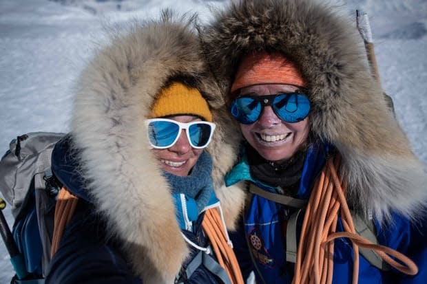 Mountaineers Eva Capozzola, left, and Pascale Marceau enjoying a celebratory moment atop Mount Lucania, Canada's third-highest peak. The pair have just returned from their 21-day expedition. (Eva Capozzola - image credit)