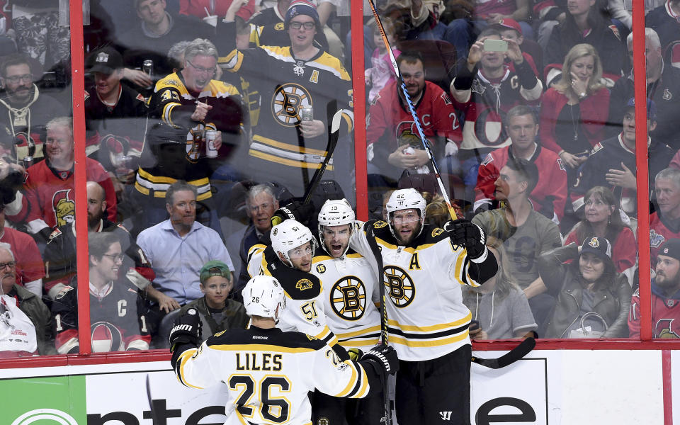 Boston Bruins right wing Drew Stafford (19) celebrates his goal with teammates John-Michael Liles (26), Ryan Spooner (51) and David Backes (42) during the second period of game two NHL Stanley Cup hockey playoff action against the Ottawa Senators, in Ottawa, Saturday, April 15, 2017. (Sean Kilpatrick/The Canadian Press via AP)