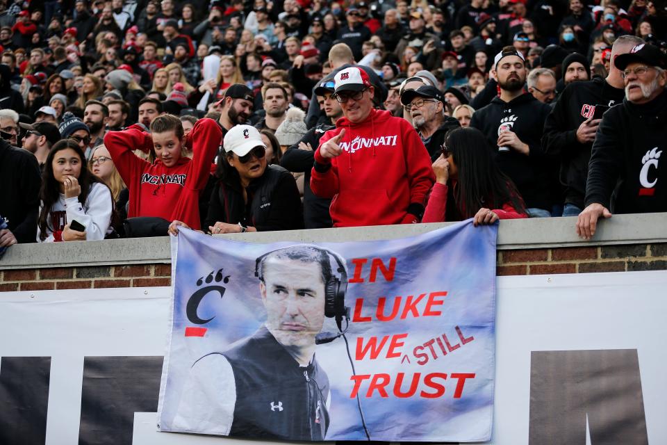 Fans show University of Cincinnati football coach Luke Fickell a little love with a flag declaring "IN LUKE WE STILL TRUST."