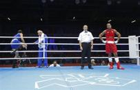 JUDGES UNDER FIRE: Iran's Ali Mazaheri (L) leaves the ring before the decision after being disqualified during his Men's Heavy (91kg) Round of 16 boxing match against Jose Larduet Gomez (R) of Cuba at the London 2012 Olympic Games August 1, 2012.