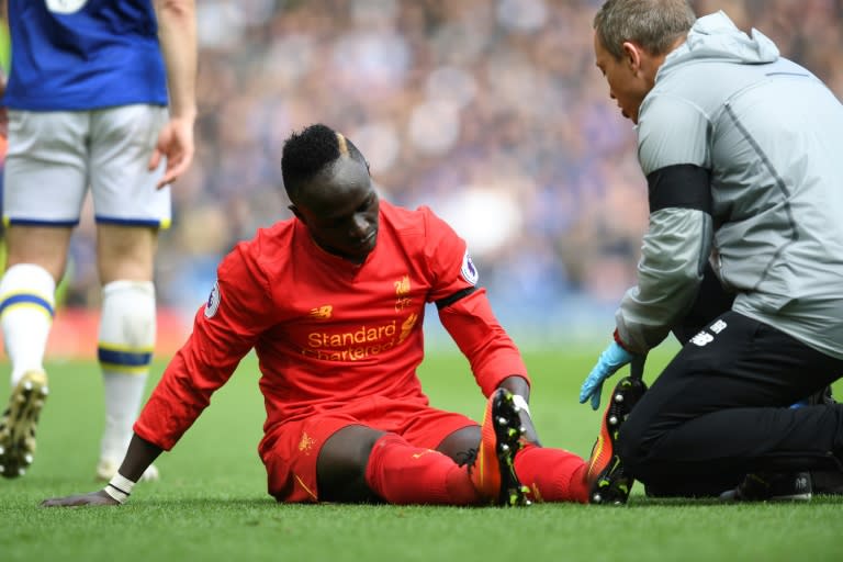 Liverpool's Sadio Mane receives medical attention after picking up an injury during the Premier League match against Everton at Anfield in north-west England, on April 1, 2017