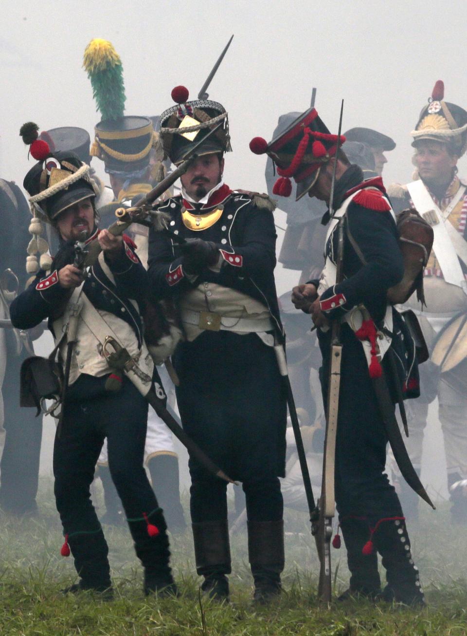 Members of historic clubs wearing 1812-era uniforms take part in a staged battle re-enactment to mark the 200th anniversary of the battle of Borodino, in Borodino, about 110 km (70 miles) west of Moscow, Sunday, Sept. 2, 2012. The Battle of Borodino in 1812 was the largest and bloodiest single-day action of the French invasion of Russia. (AP Photo/Mikhail Metzel)