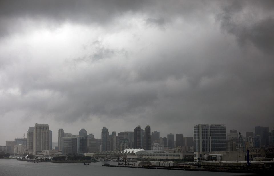 Dark clouds form over downtown San Diego as Tropical Storm Hilary passes through the area on Sunday, Aug. 20, 2023. (K.C. Alfred/The San Diego Union-Tribune via AP)