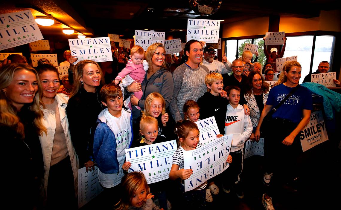 Former U.S. Senate candidate Tiffany Smiley stands next to her husband, Scotty, and family, friends and supporters in 2022 during her “New Mom in Town Tour” stop at the Clover Island Inn in Kennewick.