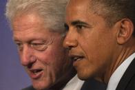 U.S. President Barack Obama (R) and former U.S. President Bill Clinton walk off the stage during the Clinton Global Initiative 2013 (CGI) in New York September 24, 2013. REUTERS/Adrees Latif (UNITED STATES - Tags: POLITICS TPX IMAGES OF THE DAY)