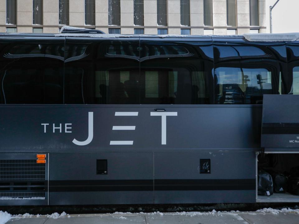 A matte black bus that reads "The Jet" on the side.