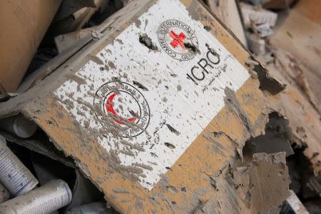 Damaged Red Cross and Red Crescent medical supplies lie inside a warehouse after an airstrike on the rebel-held Urm al-Kubra town, western Aleppo city, Syria September 20, 2016. REUTERS/Ammar Abdullah
