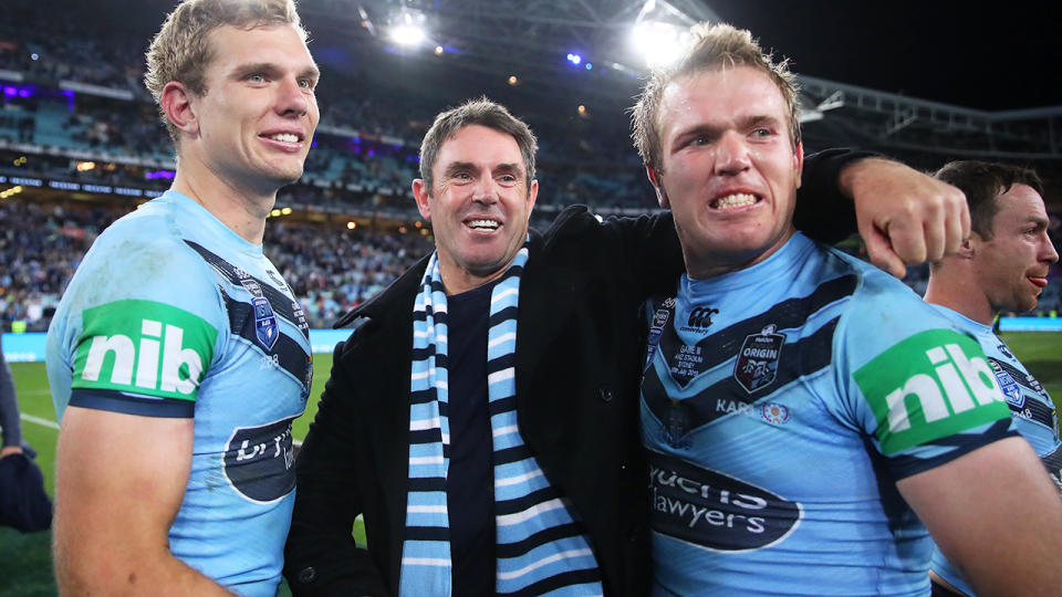 Brad Fittler, pictured here celebrating with Tom and Jake Trbojevic after NSW won the 2019 State of Origin series.